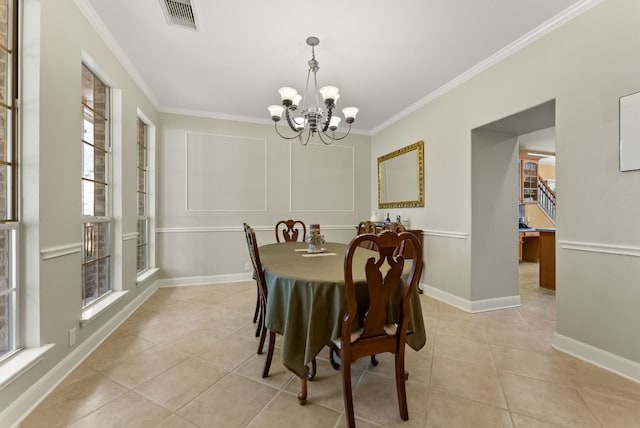 dining area featuring visible vents, an inviting chandelier, ornamental molding, and light tile patterned flooring