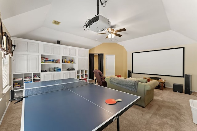 playroom featuring ceiling fan, vaulted ceiling, visible vents, and light carpet