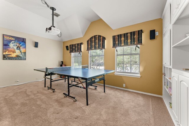 recreation room with baseboards, vaulted ceiling, visible vents, and carpet