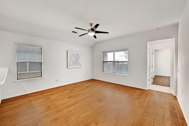 unfurnished bedroom with ceiling fan, baseboards, wood finished floors, and visible vents