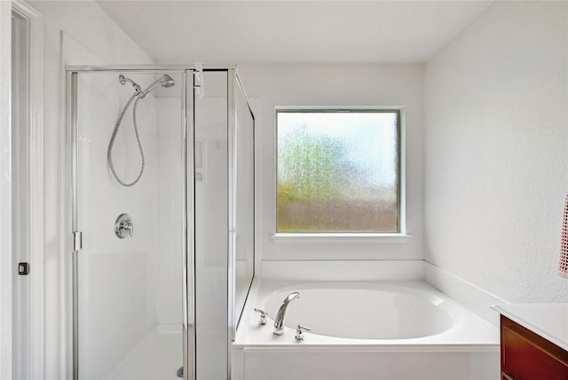 full bath with a shower stall, a garden tub, and vanity