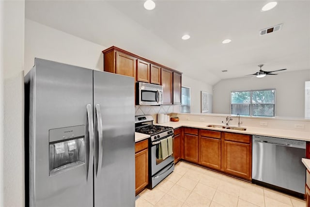 kitchen with a sink, tasteful backsplash, visible vents, light countertops, and appliances with stainless steel finishes