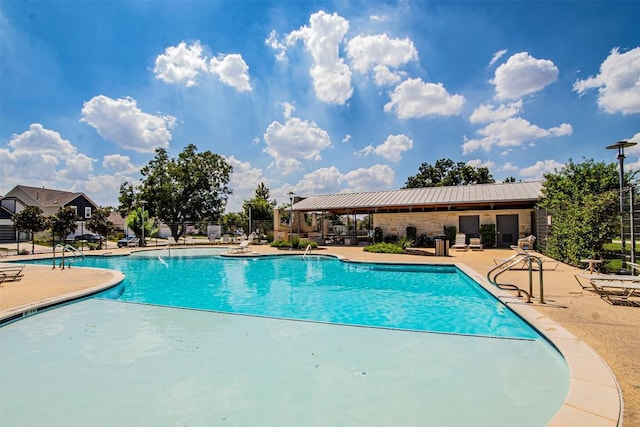 pool featuring fence and a patio