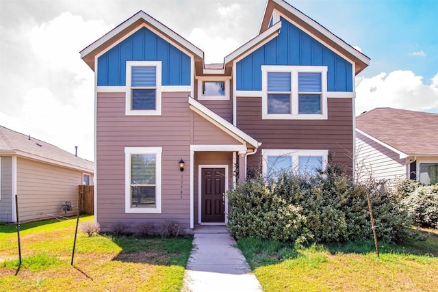 view of front facade featuring board and batten siding and a front yard
