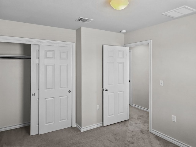 unfurnished bedroom with baseboards, carpet flooring, visible vents, and a closet