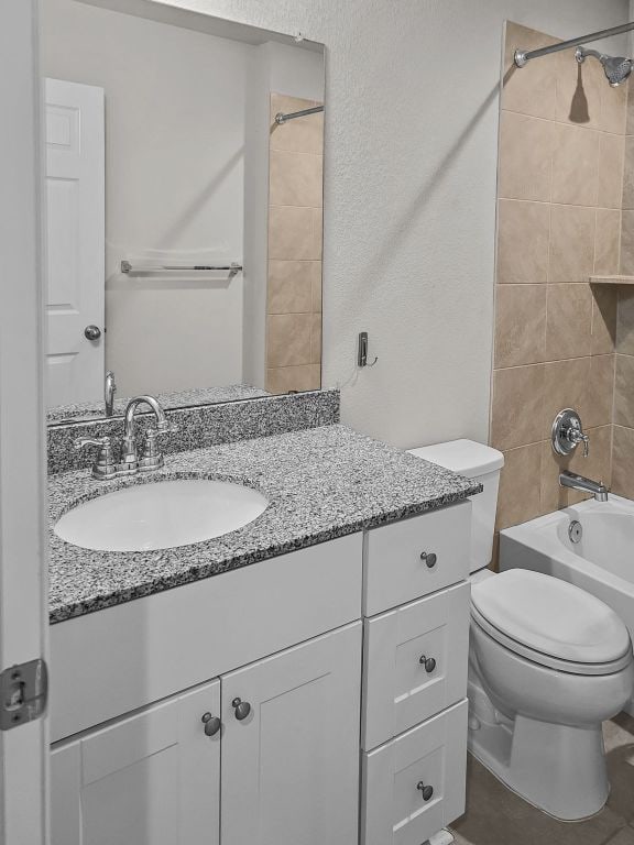 full bathroom with toilet, shower / bathtub combination, and vanity