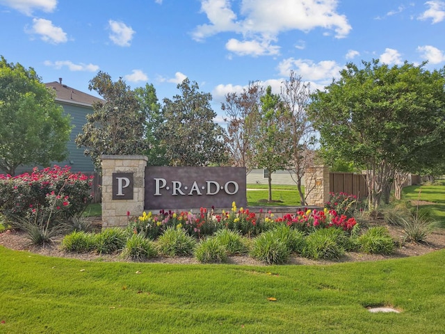community sign featuring a lawn