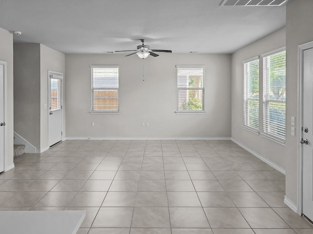 unfurnished room featuring visible vents, ceiling fan, and a healthy amount of sunlight
