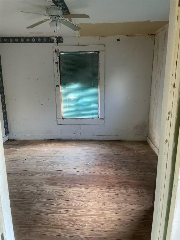 empty room with wood finished floors and a ceiling fan