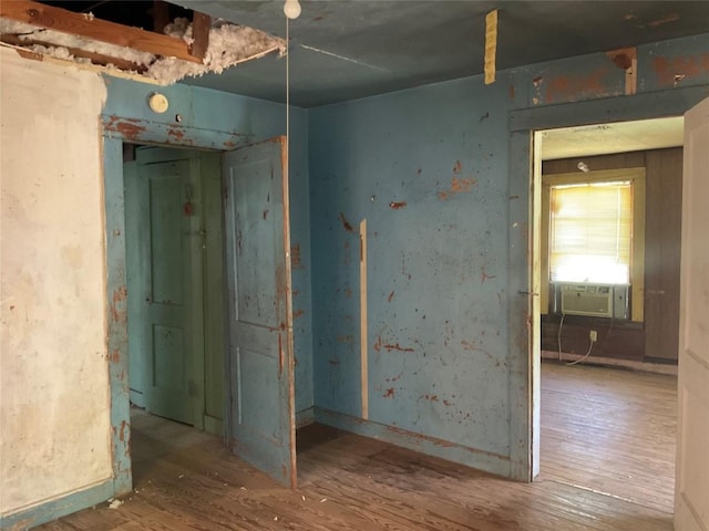 empty room featuring wood finished floors and cooling unit