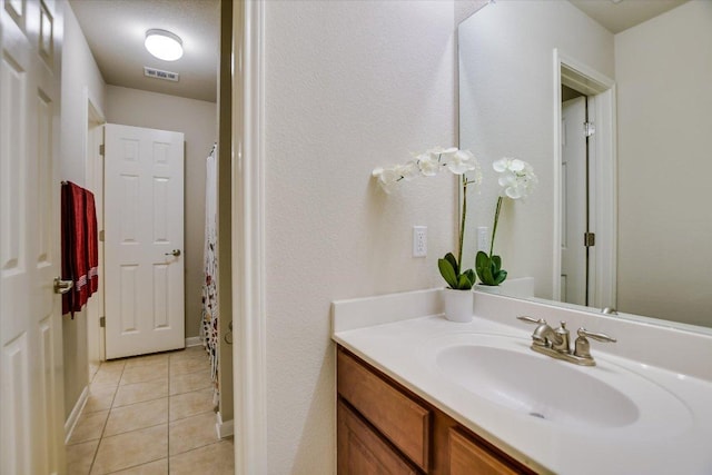 18301 Masi Loop, Pflugerville, TX 78660 - bathroom featuring tile patterned flooring, vanity, curtained shower, and baseboards