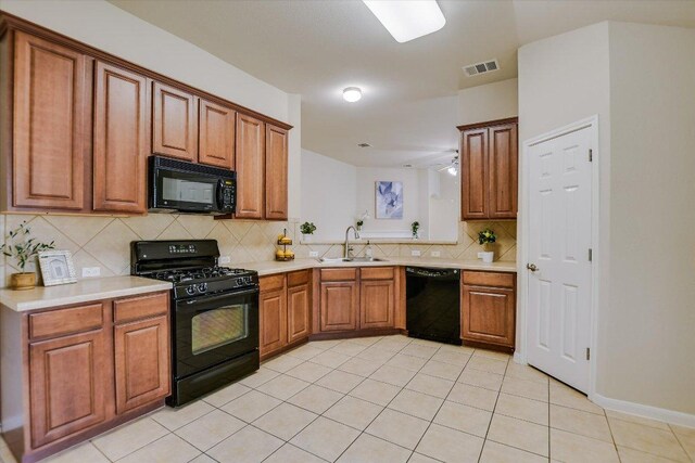 18301 Masi Loop, Pflugerville, TX 78660 - kitchen featuring black appliances, a sink, tasteful backsplash, and brown cabinets
