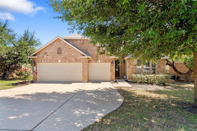 4817 Pyrenees Pass, Austin, TX 78738 - view of front of home with concrete driveway, an attached garage, and brick siding