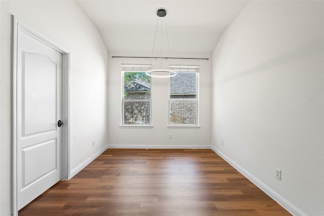 empty room featuring wood finished floors and baseboards