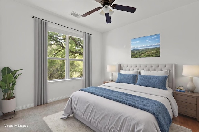 bedroom with visible vents, baseboards, a ceiling fan, and multiple windows