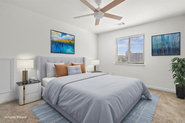bedroom with a ceiling fan, visible vents, carpet floors, and baseboards