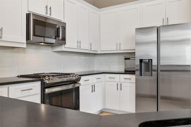 109 Perpetuation Dr, Austin, TX 78734 - kitchen with stainless steel appliances, dark countertops, white cabinetry, and backsplash