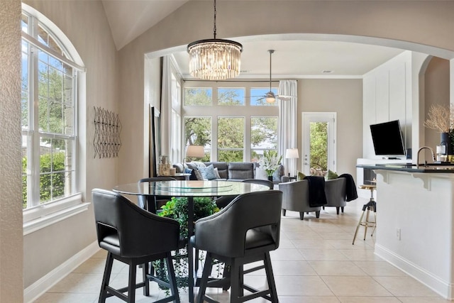 109 Perpetuation Dr, Austin, TX 78734 - dining room featuring arched walkways, light tile patterned floors, baseboards, a chandelier, and lofted ceiling