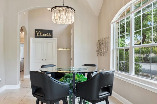 109 Perpetuation Dr, Austin, TX 78734 - dining area featuring arched walkways, baseboards, a chandelier, lofted ceiling, and light tile patterned flooring