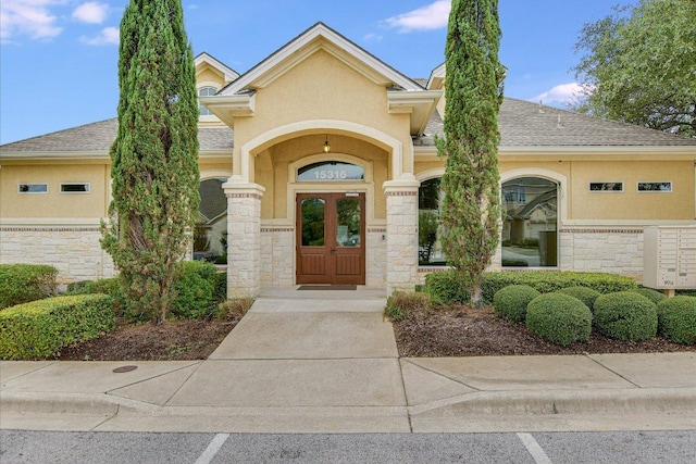 109 Perpetuation Dr, Austin, TX 78734 - view of exterior entry with stone siding, roof with shingles, and stucco siding