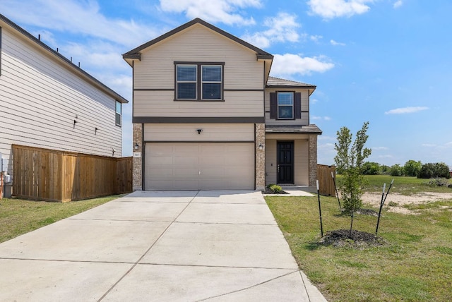 traditional-style home featuring an attached garage, fence, driveway, and a front lawn