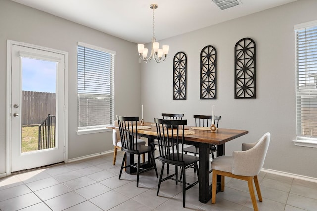 dining room with light tile patterned floors, an inviting chandelier, visible vents, and baseboards