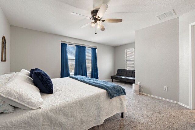 bedroom featuring carpet, visible vents, a ceiling fan, and baseboards