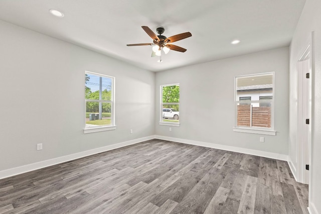 spare room featuring recessed lighting, wood finished floors, baseboards, and ceiling fan