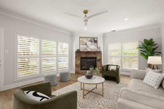10906 Rickerhill Ct, Austin, TX 78739 - living room with ornamental molding, a glass covered fireplace, baseboards, wood finished floors, and a ceiling fan