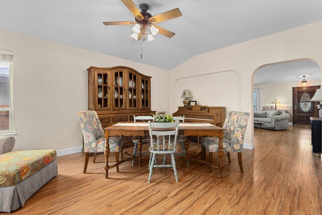 3325 Cantera Way, Round Rock, TX 78681 - dining space with arched walkways, vaulted ceiling, ceiling fan, light wood-type flooring, and baseboards