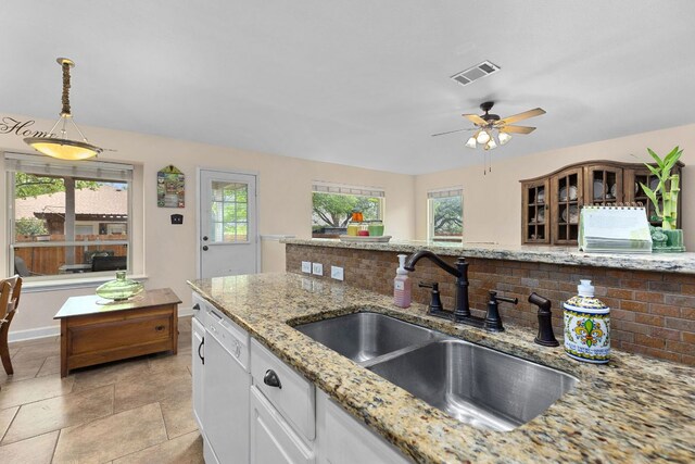 3325 Cantera Way, Round Rock, TX 78681 - kitchen with dishwasher, a sink, healthy amount of natural light, and decorative backsplash