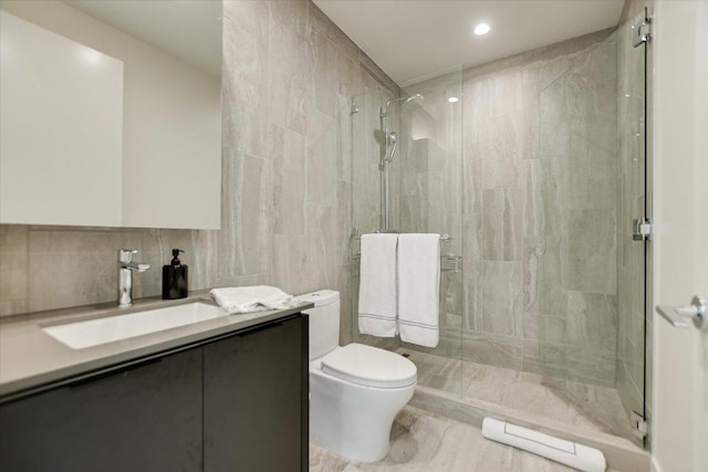 44 E Ave Unit 3906, Austin, TX 78701 - full bathroom with tile walls, a tile shower, vanity, and recessed lighting