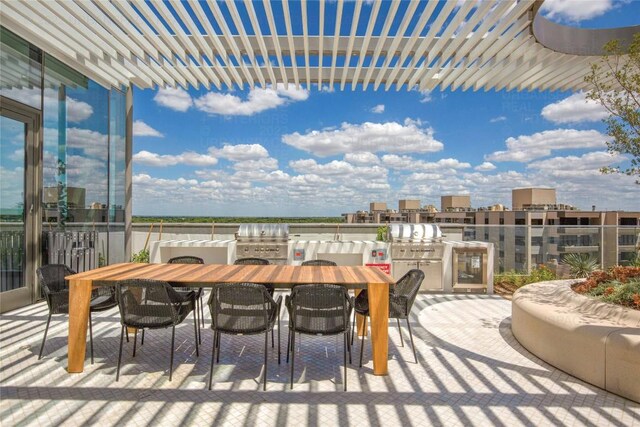 44 E Ave Unit 3906, Austin, TX 78701 - view of patio / terrace featuring outdoor dining space, exterior kitchen, and a pergola