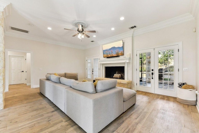 203 Saddle Blanket Dr, Dripping Springs, TX 78620 - living room featuring a ceiling fan, light wood-type flooring, crown molding, recessed lighting, and a fireplace with raised hearth