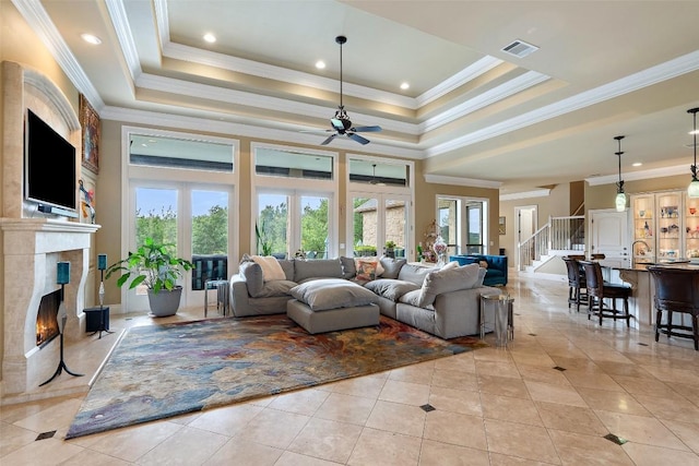 4616 High Gate Dr, Austin, TX 78730 - living area featuring ceiling fan, a premium fireplace, light tile patterned floors, ornamental molding, and a raised ceiling