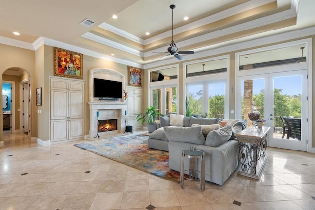 4616 High Gate Dr, Austin, TX 78730 - living room with a raised ceiling, crown molding, french doors, a ceiling fan, and arched walkways