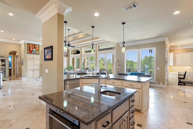 4616 High Gate Dr, Austin, TX 78730 - kitchen featuring an island with sink, ornamental molding, arched walkways, recessed lighting, and cream cabinetry