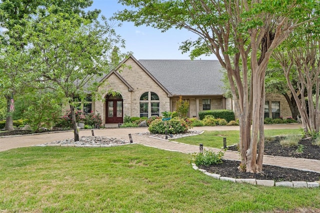 4616 High Gate Dr, Austin, TX 78730 - view of front of house with a front lawn, french doors, roof with shingles, and brick siding