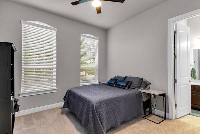 2601 Montebelluna Pl, Leander, TX 78641 - bedroom featuring light colored carpet, ensuite bath, and ceiling fan
