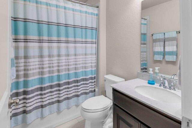 2601 Montebelluna Pl, Leander, TX 78641 - full bathroom with vanity, shower / bath combo with shower curtain, and a textured wall