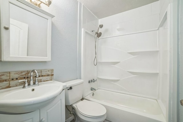 bathroom with a textured wall, toilet, vanity, tasteful backsplash, and bathtub / shower combination