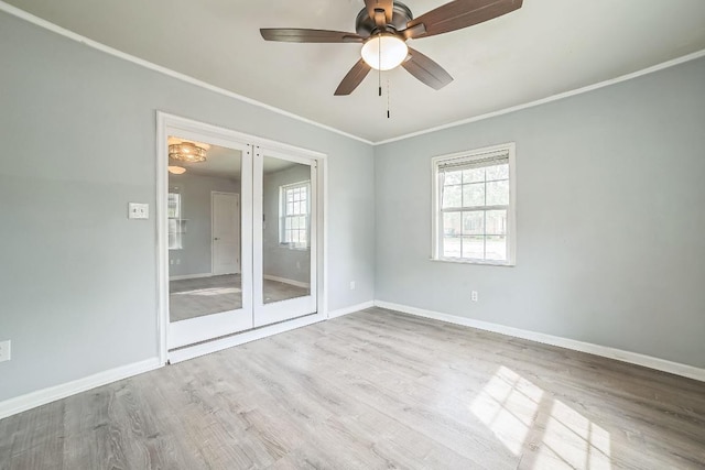 spare room featuring wood finished floors, ornamental molding, and a healthy amount of sunlight