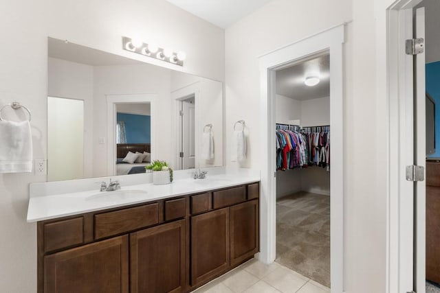 17109 Calipatria Ln, Pflugerville, TX 78660 - ensuite bathroom featuring double vanity, tile patterned floors, and a walk in closet