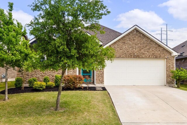 17109 Calipatria Ln, Pflugerville, TX 78660 - view of front of house with brick siding, a garage, concrete driveway, a front lawn, and roof with shingles