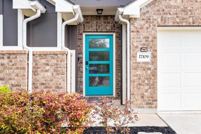 17109 Calipatria Ln, Pflugerville, TX 78660 - property entrance with an attached garage and brick siding