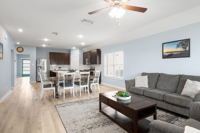 17109 Calipatria Ln, Pflugerville, TX 78660 - living room featuring light wood finished floors, plenty of natural light, ceiling fan, and recessed lighting