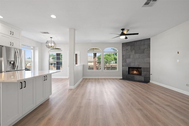 1006 Mesquite Hollow Pl, Round Rock, TX 78665 - unfurnished living room featuring baseboards, ceiling fan, plenty of natural light, recessed lighting, and light wood finished floors