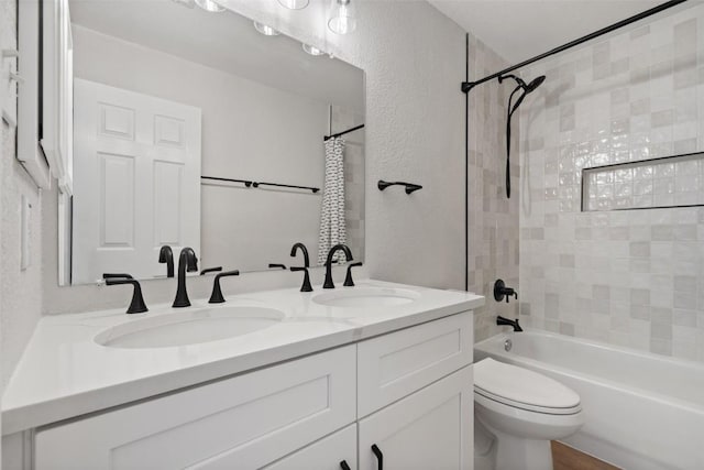 1006 Mesquite Hollow Pl, Round Rock, TX 78665 - full bath featuring a textured wall, double vanity, toilet, and shower / bath combo