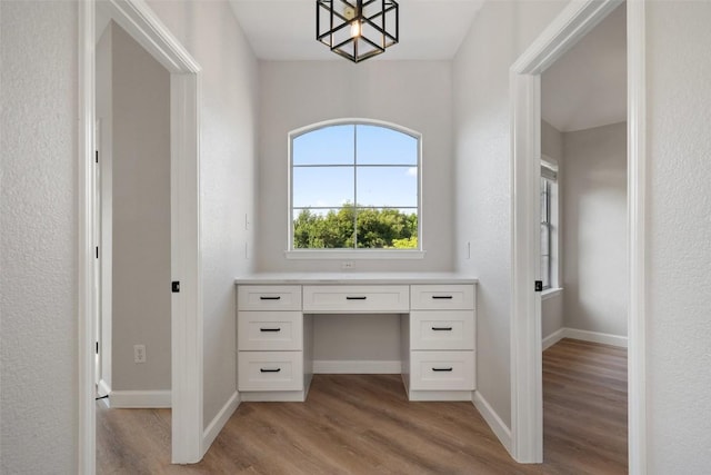 1006 Mesquite Hollow Pl, Round Rock, TX 78665 - unfurnished office with light wood-style floors, baseboards, and a chandelier