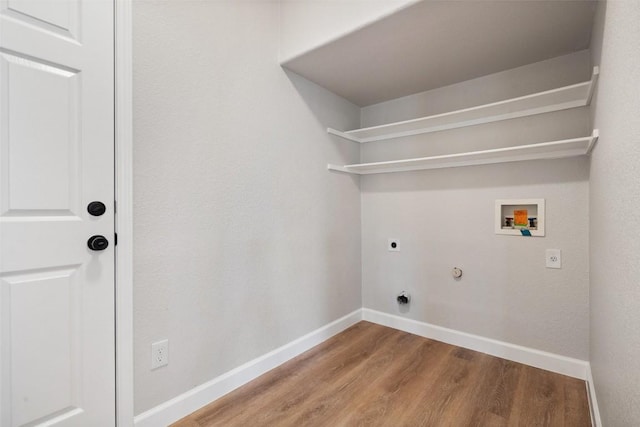 1006 Mesquite Hollow Pl, Round Rock, TX 78665 - laundry room featuring electric dryer hookup, washer hookup, wood finished floors, baseboards, and gas dryer hookup